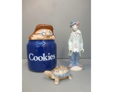 A Lladro figure of a clown, a Wade Tetley cookie jar and a Wade tortoise.