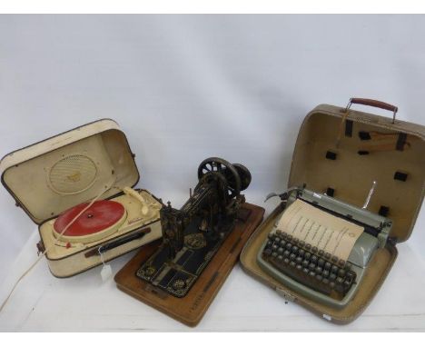 A Teppaz Presence portable record player, a portable typewriter and a cased Frister and Rossmann sewing machine.