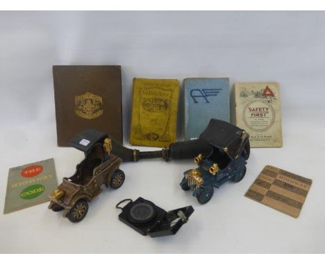 Two ceramic Bretby vintage cars, a Lucas King of the Road No. 6 car horn, a compass, and an assortment of volumes relating to