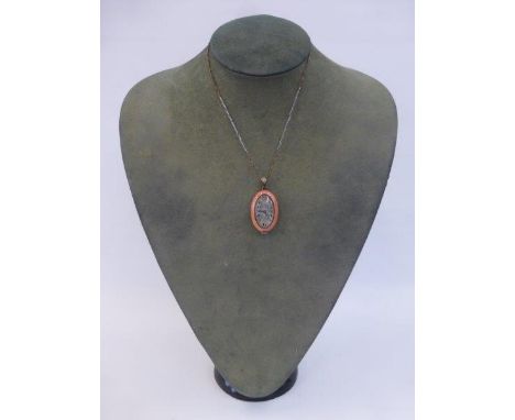An oval pink cloisonne enamel cased pendant watch with a platinum chain.