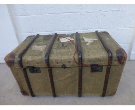A large canvas and wooden bound travel trunk (with some original labels), containing an  internal tray, also a leather suitca