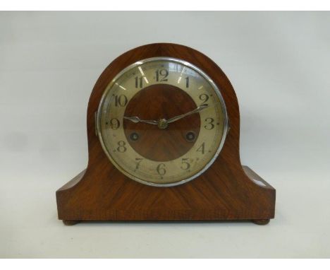 A 1930s German walnut cased mantle clock fitted with a "rack strike" movement.