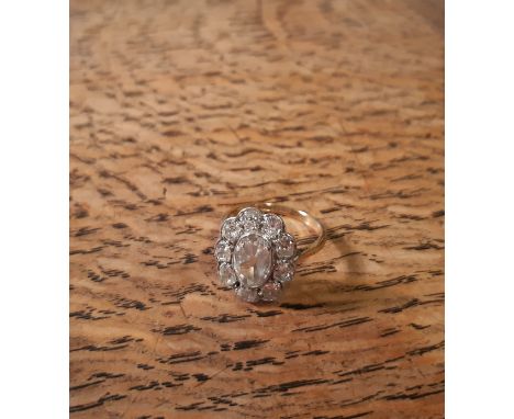 18ct gold and platinum mounted all diamond Flowerhead ring, central oval stone approx 1.5ct, surrounded by nine circular ston