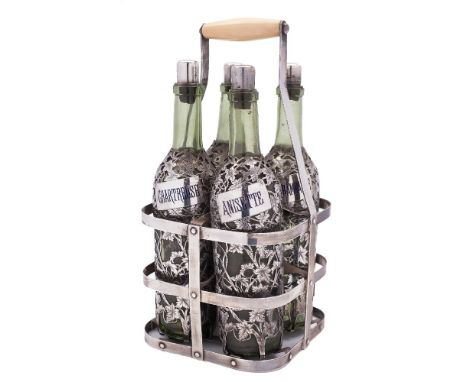 A late 19th/early 20th century French silver four-bottle tantalus: of rectangular outline with ivory handle containing four g