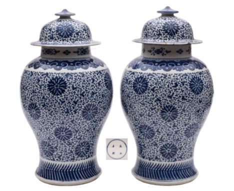 A pair of Chinese blue and white 'peony scroll' baluster jars and covers: painted overall with a design of peonies and scroll