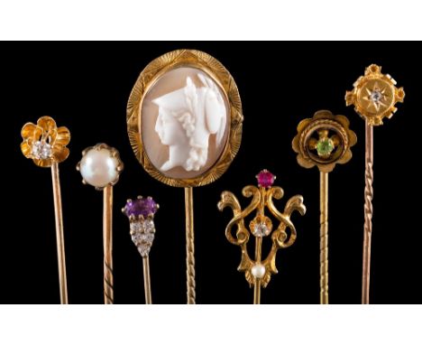 A 19th century gold stick-pin: with circular granulation work panel in the style of Castellani, a single diamond-set stick-pi