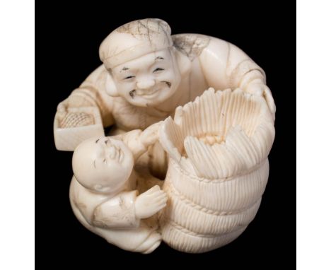 A Japanese carved ivory netsuke: depicting Daikoku with a bale of rice and a karako boy, signed to a red lacquer tablet, 5.5c