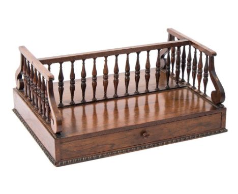 A Regency rosewood double sided book trough: of rectangular outline, with galleried top and bobbin turned beading, 42cm. wide