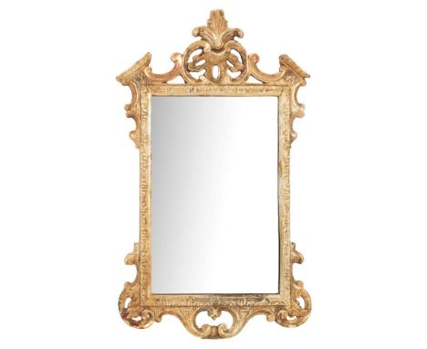A carved giltwood and gesso wall mirror in the 18th Century style:, with an architectural pediment centred by palmette foliag