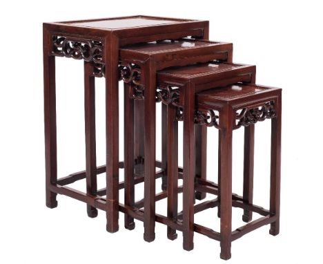 A set of Chinese hardwood quartetto tables:, with amboyna rectangular tops and pierced scroll aprons, on square section legs,