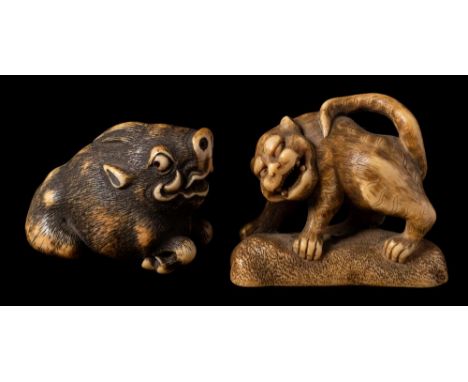 A Japanese ivory netsuke of a wild boar and an okimono of a shishi: the first with ebony eyes, its carved and stained fur fin