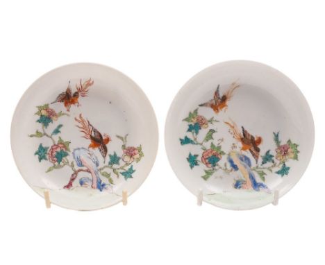 A pair of Chinese famille rose saucers: each finely painted with two phoenix, blue rock work and a tree peony, Yongzheng/earl