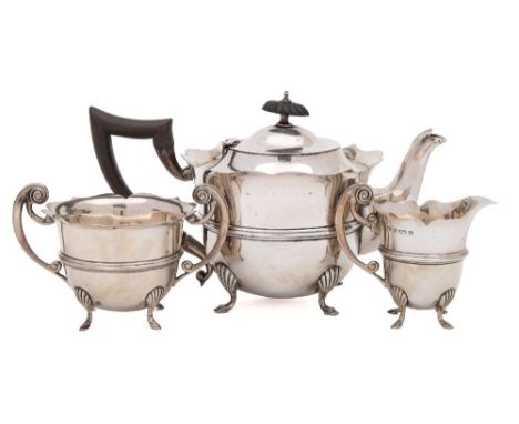An Edward VII silver three-piece tea service, maker William Aitken, Birmingham, 1902: of circular outline with wavy edge bord