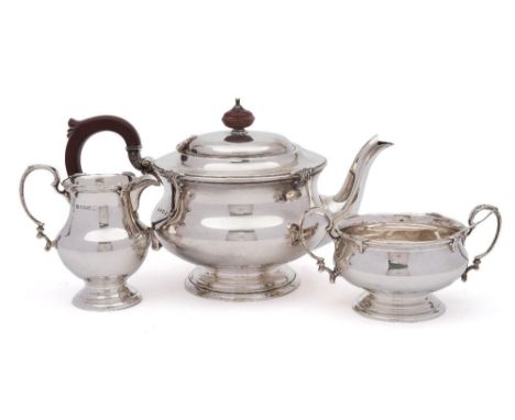 A George V silver three-piece tea service, maker Adie Brothers Ltd, Birmingham, 1934: of circular outline, with foliate decor
