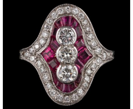 An Art Deco ruby and diamond cluster ring: with central row of round brilliant-cut diamonds within a surround of calibre-cut 