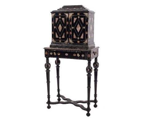 An 18th Century Italian ebonised, ivory and marbled cabinet on a later stand:, bordered with ivory lines and inset with oval,