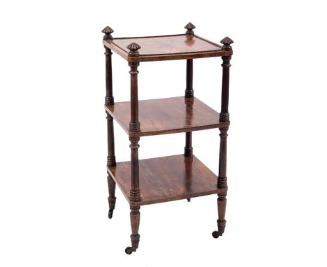 A Regency rosewood square three tier whatnot:, with reeded pointed finials and ring turned uprights, on tapered legs, brass c