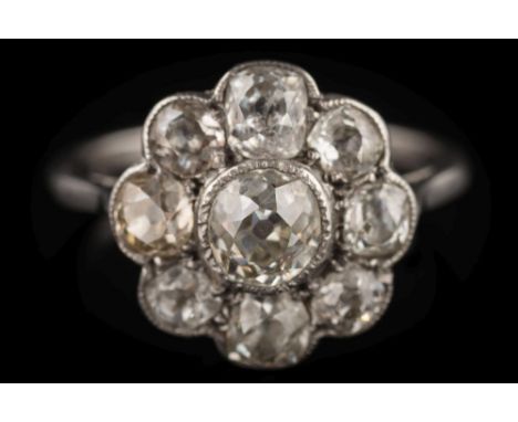 A diamond mounted circular cluster ring: with central round old brilliant-cut diamond approximately 0.50cts in millegrain set
