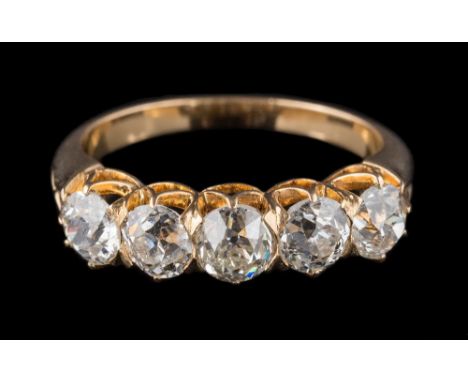 A late 19th century gold and diamond five-stone half-hoop ring: with five slightly graduated round old brilliant-cut diamonds