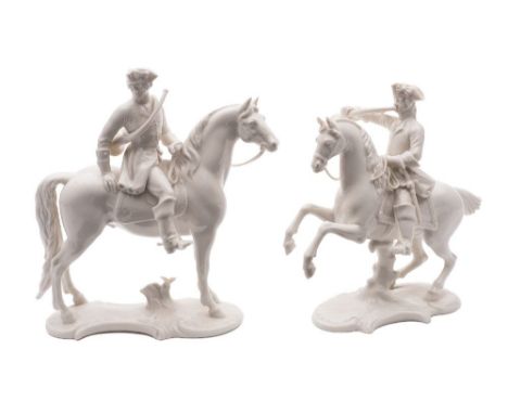 Two Nympenburg white porcelain equestrian figures of huntsmen: after 18th century originals, both with hunting horns and on s