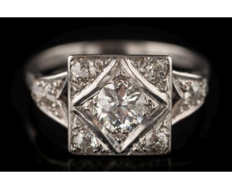 An Art Deco diamond square cluster ring: the central old, brilliant-cut diamond estimated to weigh  0.50ct and between splaye