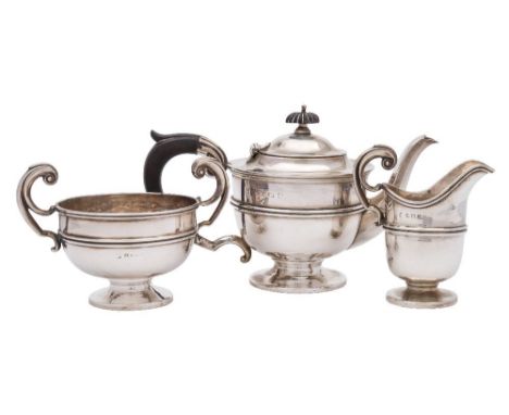A George V silver three-piece tea service, maker's marks worn, Birmingham, 1912:  of plain circular form with reeded girdle, 