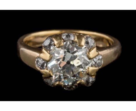 A late 19th century gold and diamond ring: the principal cushion-shaped old, brilliant-cut diamond approximately 9.7mm long x