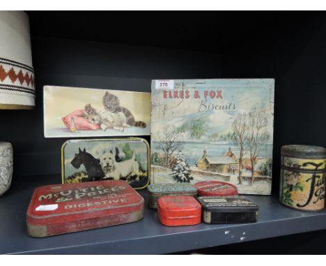 A selection of vintage advertising tins including Elkes And Fox, and dog and cat prints