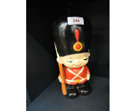 A vintage ceramic money box in the style of a Royal guard