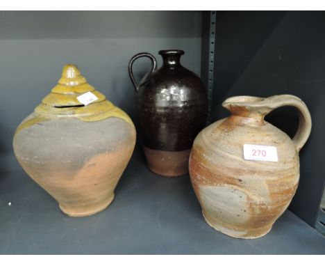 A selection of vintage art house and earthen ware pottery including money box and jugRestoration to handle of black glaze top