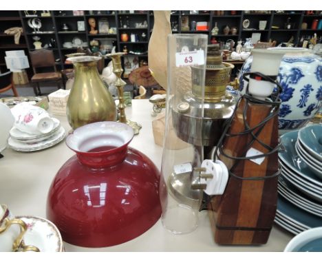A vintage Aladdin oil burning lamp and wooden lamp base