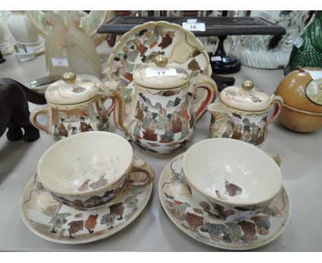 A vintage ceramic tea set for two Japanese Satsuma ware hand decorated