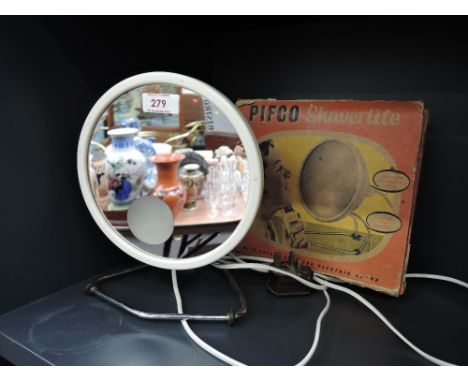 A vintage shaving mirror by Pifco with integral light and box