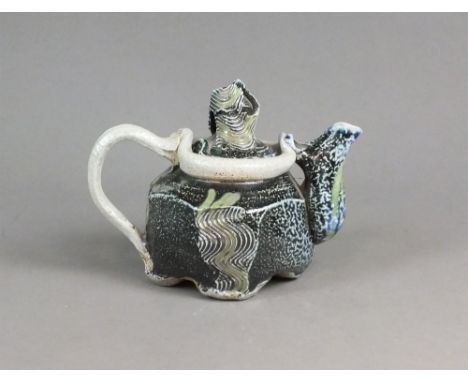 Ruthanne Tudball (American, 1948) a teapot and cover in green, blue and black, potters' seal mark, 14cm high Ruthanne Tudball