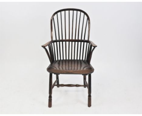 An elm and yew wood stick back Windsor Chair, 19 th century, with saddle seat and raised on turned splayed legs joined by an 