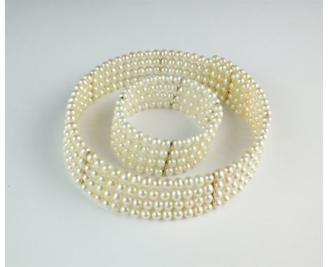 A multi strand freshwater cultured pearl collarette and bangle, each formed as four rows of cultured pearls with yellow metal