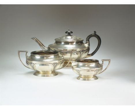 An Edwardian three piece silver tea service, Levesley Brothers, Sheffield 1907, each piece of oval form with Art Nouveau deco