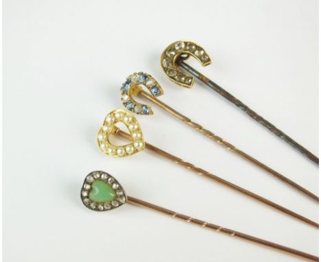 A collection of four stick pins, comprising a heart shaped green stone and rose cut diamond example, a sapphire and diamond h