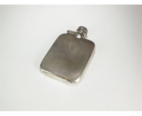 A silver hip flask, Birmingham 1926, of rectangular form with engine turned finish and hinged screw cap, 11cm high, weight ap