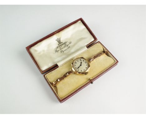 A Lady's 9ct gold wristwatch, the circular silvered dial with Arabic numerals, manual wind, with attached 9ct gold expanding 