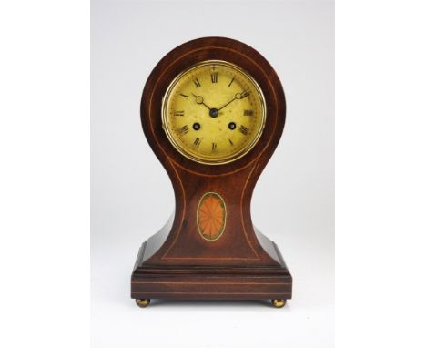 An Edwardian mahogany and inlaid balloon shaped mantel clock, the 4” gilt foliate engraved dial with Roman numerals, and 8-da