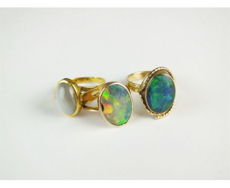 A banded agate dress ring, together with two opal dress rings (at fault) (3)