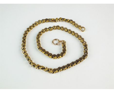 A yellow metal decorative link necklace, designed as star cut and twist links, with plaque stamped '15', the bolt ring clasp 