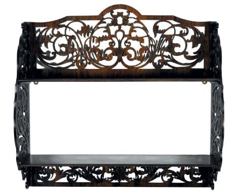 A rosewood two height open hall shelf, early 19th century, the top panel, sides and apron with pierced openwork foliate detai