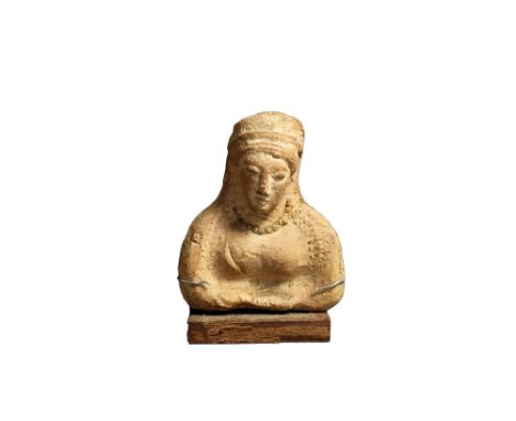 East Greek, ceramic, 6th-5th century BC; a plaque depicting a goddess, possibly Demeter, hairs parted in the centre and falli