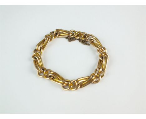 A yellow metal twist and circular link bracelet, with bolt ring clasp stamped '15', with attached safety chain, total weight 