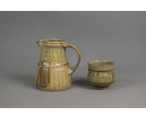 JIM MALONE (born 1946) A studio pottery jug and vase, each in green glazed stoneware, impressed JM seal marks, 14.5cm and 8cm