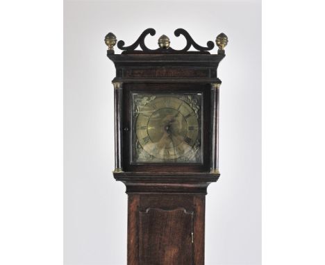 A George III oak cottage longcase clock, the open scroll work pediment with three brass finials above a square glazed door en