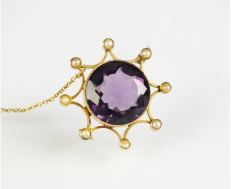 A late 19th/early 20th century amethyst and seed pearl brooch, designed as a central round mixed cut amethyst milligrain set 