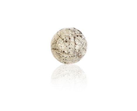 ROBERT FORGAN &amp; SON: A RANDOMLY HAND HAMMERED GUTTA-PERCHA GOLF BALL, CIRCA 1870Complete with its yellow paper Glasgow In